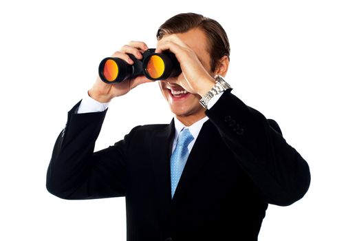 Business professional looking through binoculars. Isolated on white