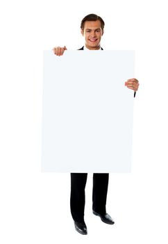 Young business executive promoting big blank banner ad isolated on white