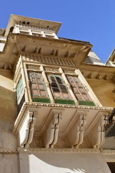 Vertical of intrinsic Rajasthan architecture with galleries to bedroom windows and shutters having intricate carvings