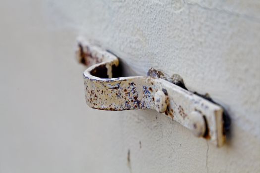 Any orientation rusty eye but where is the bolt, mounted on a white emulsion paint breeze block wall