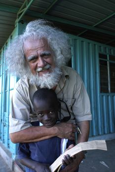 Nairobi, Kenya, March 16, 2008 - Father Kizito Sesana embraces a child.Father Kizito Comboni missionary work in Kenya since 1994,founder of the Koinonia community association that brings together the abandoned children of Kenya