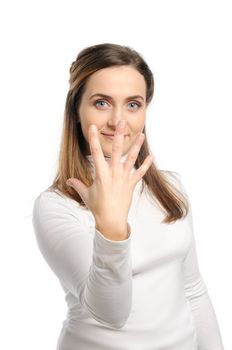 Young attractive girl shows gesture of the figure five. Isolated on white.