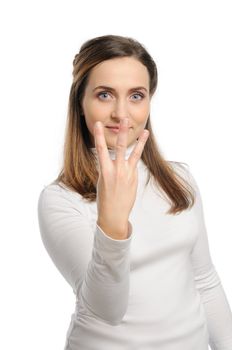 Young attractive girl shows gesture of the figure three. Isolated on white.