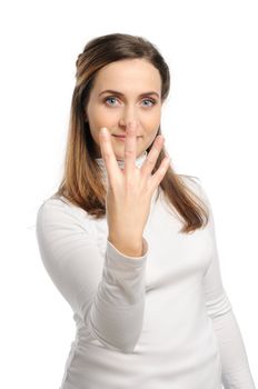 Young attractive girl shows gesture of the figure four. Isolated on white.