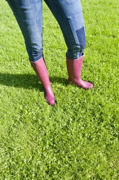 detail of woman wearing rubber boots on lawn