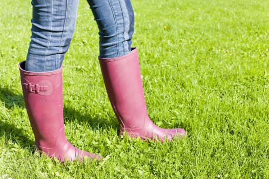 detail of woman wearing rubber boots on lawn