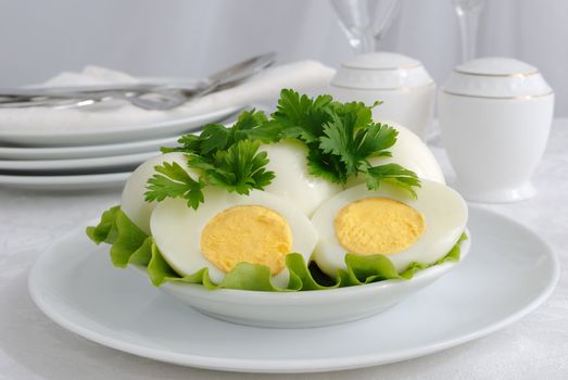 Boiled eggs in a cut greens on a plate