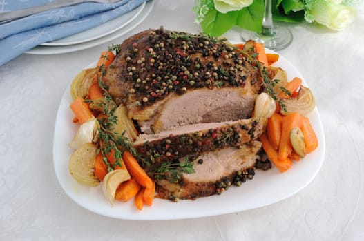 A piece of pork hams at different peppers and carrots and onions closeup