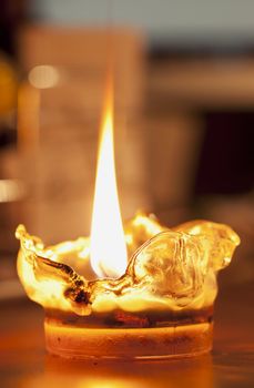 Melting plastic lit candle with big flame