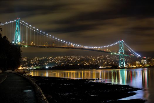 Lions Gate Bridge Over English Bay in Vancouver BC Canada at Night