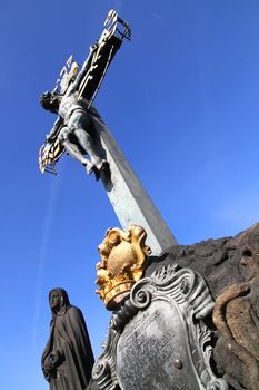 A cross on the Charles Bridge in Prague, Czech republic.