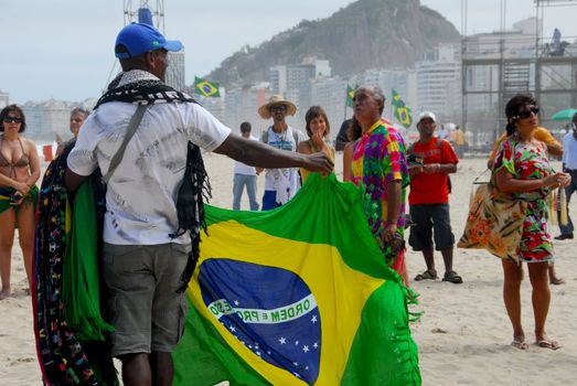 Rio de Janeiro, Brazil 2 octobre 2009: A street vendor on the beach of Copacabana in Rio De Janeiro celebrates the victory of Rio De Janeiro for the 2016 Olympics