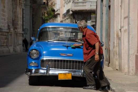 La Habana, Cuba - February 8, 2009: A Cuban cleans its magnificent old American cars. In Cuba there are many old American car collection