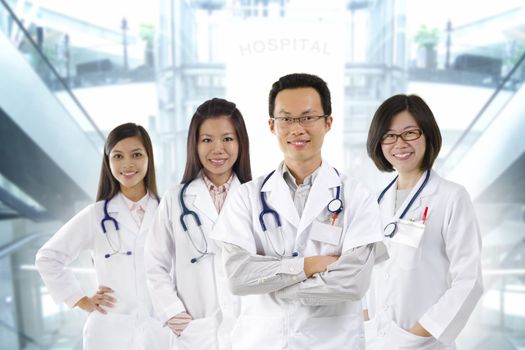 Asian medical team standing inside hospital building