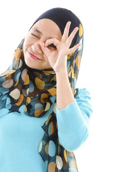 Young muslim woman focused by hand hole