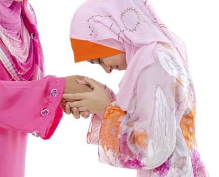 Young Muslim women greeting to elders