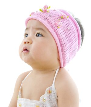 Curious Asian baby girl looking at blank side