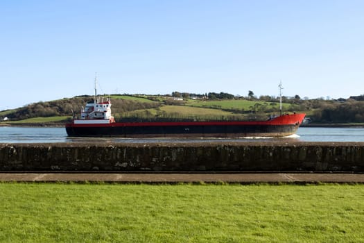 cargo ship sailing past as seen from the sea wall in Youghal county Cork