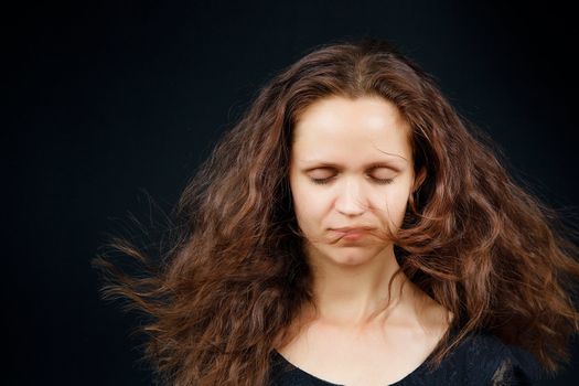 attractive girl with closed eyes and flowing long hair