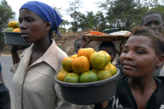 Malawi-April 25,2007: woman selling fruit at bus stops. in a many bus stations women sell fruit to the passengers of the bus