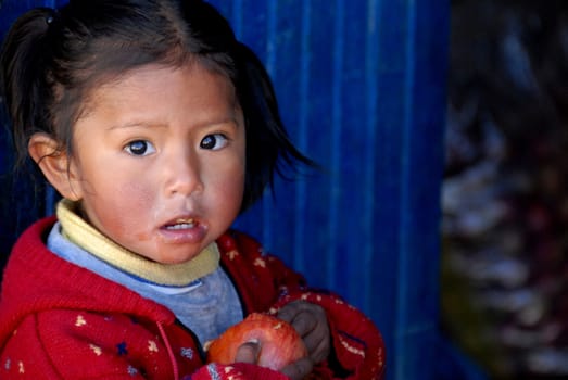 La Paz, Bolivia in September 2009: a sweet little girl with an apple in hand