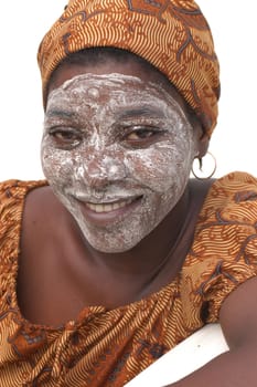 Mozambique Island, Mozambique, May 2, 2004: African woman with the cream of Musiro a paste obtained by rubbing a stone on a piece of a tree branch Olax locale.Il miraculous mixture is used to treat the skin. Does it make it softer and removes stains.