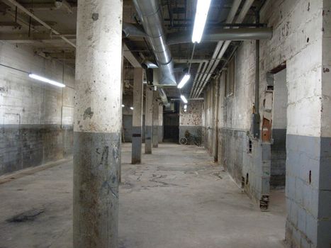 Empty older warehouse / commercial space with lights on