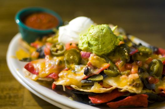 Nachos with cheese, guacamole, and sour cream