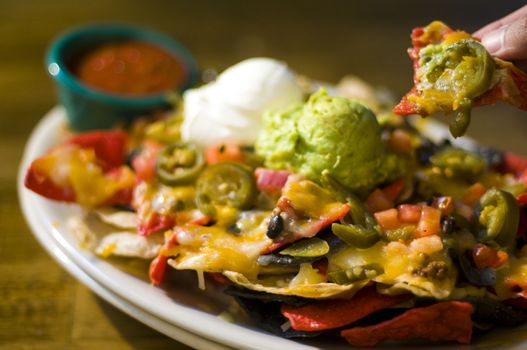 Nachos with cheese, guacamole, and sour cream