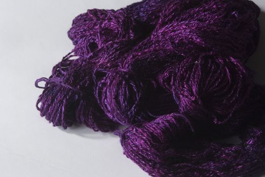 Handmade bundle of purple yarn on white