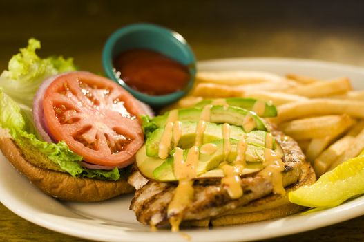 Avocado chicken burger with fries