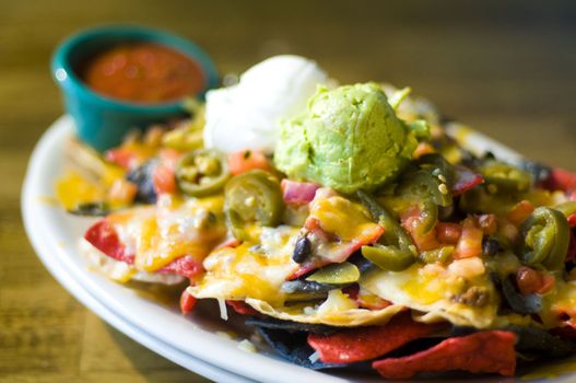 Nachos with cheese, guacamole, and sour cream