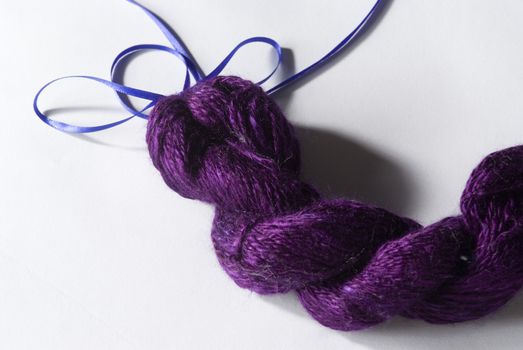 Handmade bundle of purple yarn on white