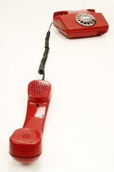 a red retro phone on white............