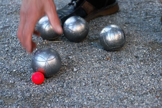 silver boccia ball on the ground