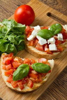 italian bruschetta with fresh tomatoes, basil, garlic, olive oil and cheese