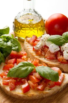 italian bruschetta with fresh tomatoes, basil, garlic, olive oil and cheese