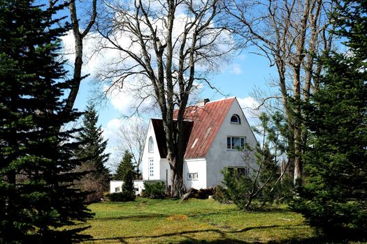 The old wooden house is near to trees