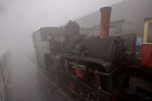 Famous tourist attraction, small funicular steam loco on the top of Snowdon mountain in Wales, UK