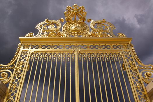 Golden gate of Versailles Palace near Paris moments before the storm