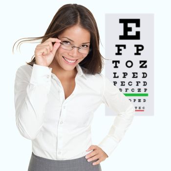 Optician or optometrist showing Snellen eye exam chart wearing eye wear glasses. Female mixed race Caucasian / Asian Chinese model