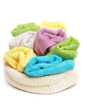 Multi-colored Terry towels in wattled container isolated on white background
