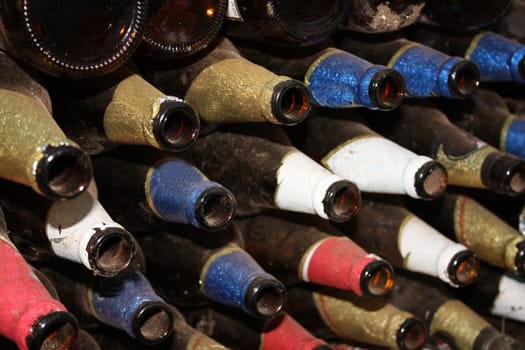 A background of a stack of old beer bottles kept for recycling.