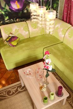 room corner with a sofa and a little table with ware and an orchid, the top view