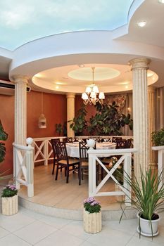 Interior of cozy modern restaurant. a vertical shot, a view of the improvised arbor with columns