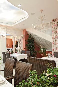 Interior of cozy modern restaurant. vertical shot, view of little tables