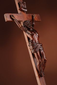 The crucifixion. Wooden sculpture on dark background