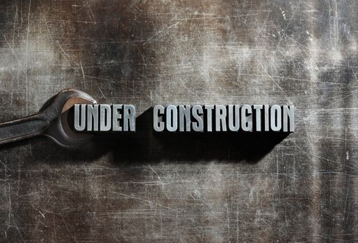 Image of a Under Construction sign with a metallic background texture