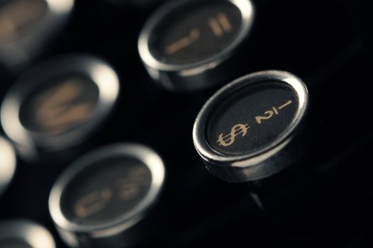 Close up photo of antique typewriter keys, shallow focus on dollar symbol