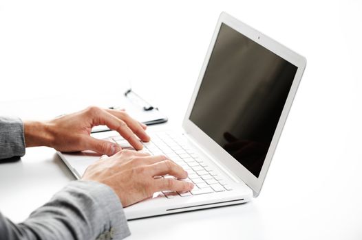 Businessman working at laptop computer, white background